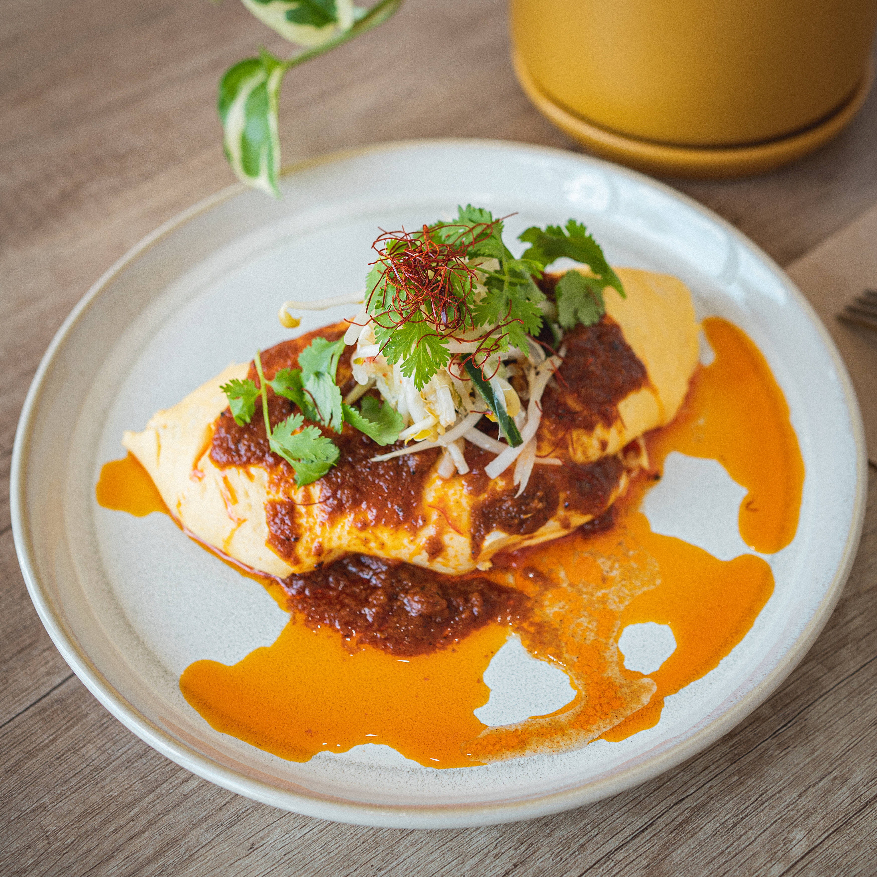 Café Eighty2’s golden omelette with fresh herbs and a rich orange sauce