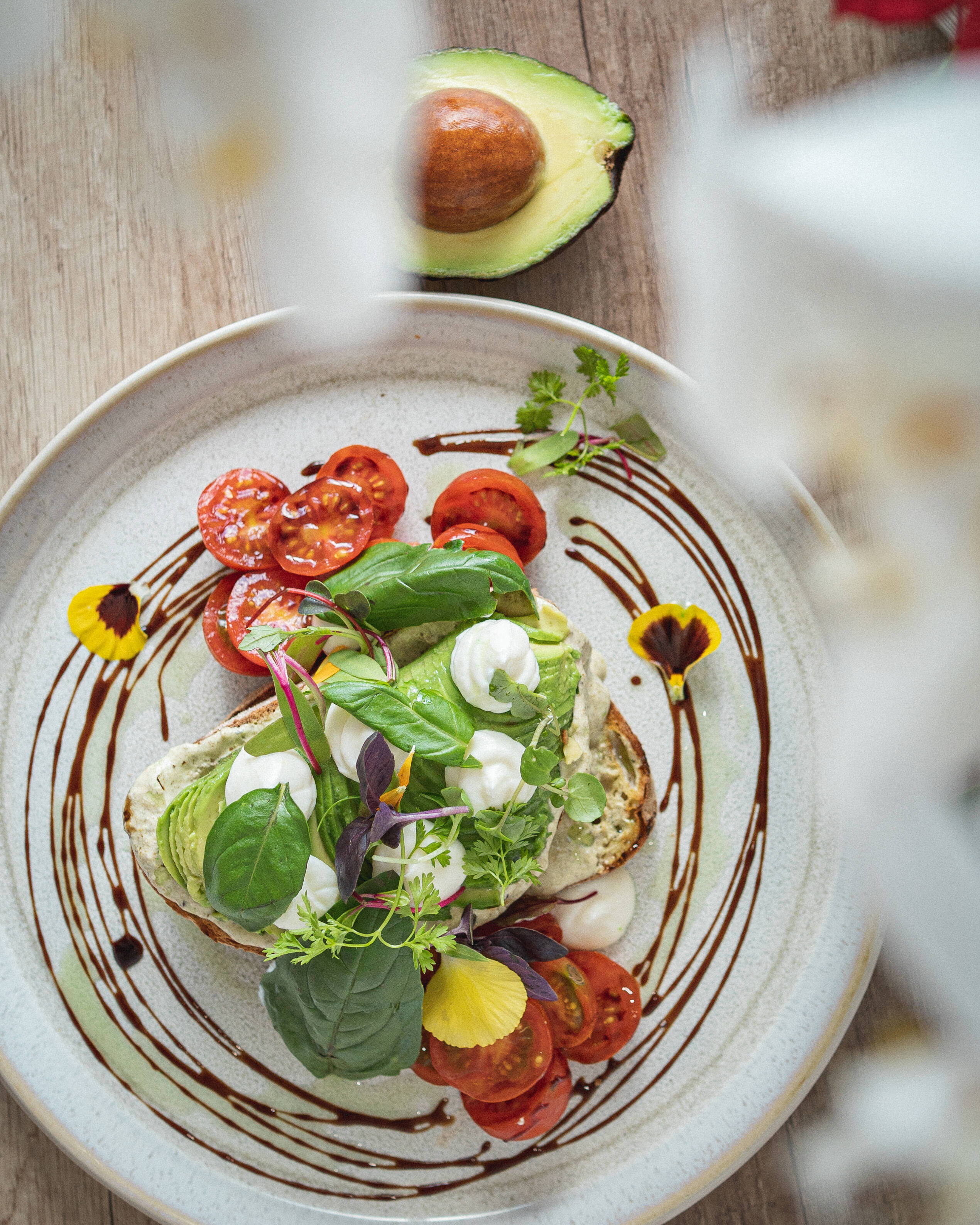 Café Eighty2’s avocado toast with tomatoes, fresh leaves and edible flowers